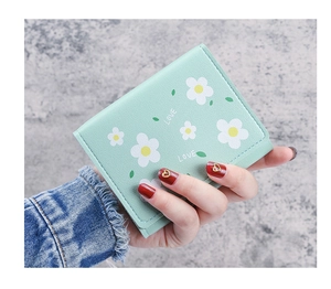 Détail du portefeuille vert menthe avec motifs marguerites et inscription LOVE