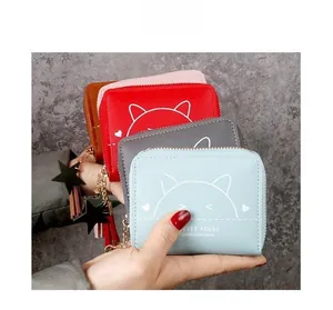 Detail of short wallets with cute cat prints and star zipper pulls in multiple colors