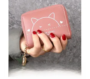 Close-up of pink PU leather wallet with cat print, star tassel, and metal zipper