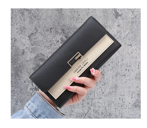 Close-up of trifold long wallet in black and beige PU leather held by a model