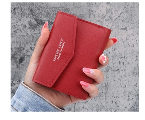 Nahaufnahme einer roten, kurzen Damen-Börse mit Forever Lovely Prägung im Detail
