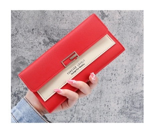 Close-up of red and beige patchwork long wallet featuring a metal buckle and pebble texture