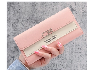 Detail of pink and beige trifold long wallet with silver buckle and textured PU leather