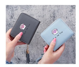 Close-up of compact PU leather wallets with cute cat paw design and tassel zipper