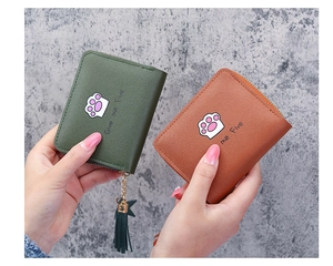 Detailed view of mini PU leather wallets featuring cat paw print and tassel zipper detail