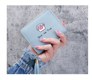Detail of light blue faux leather wallet featuring a cat paw print and star tassel charm