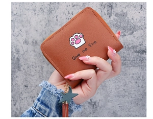 Detail of short brown zipper wallet featuring cartoon cat paw print and star tassel