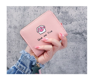 Detailed close-up of pink short wallet with cat paw print and star tassel charm