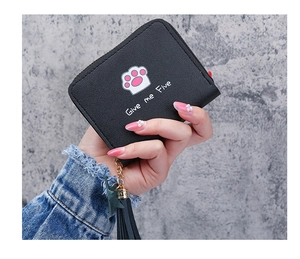 Close-up of black leather wallet with pink cat paw logo and black tassel detail