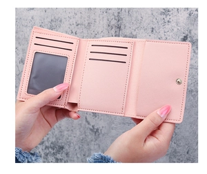 Pink daisy tri-fold wallet showing card slots and transparent ID holder detail