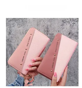Detail of pink PU leather long zip wallet with sequin patchwork and heart charm