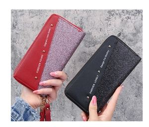 Close-up of long zip-around wallets with sequin stitching, rivets and wrist straps