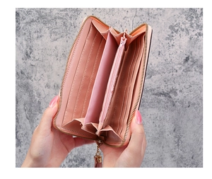 Detailed interior of the long pink zip wallet showing card slots and storage compartments