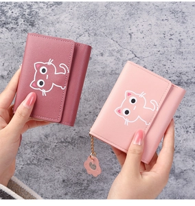 Detail of short PU leather wallets with cat pattern and cute paw pendant for women