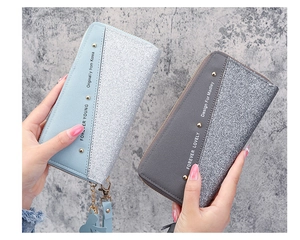 Detail of long zipper wallet with glitter patchwork design and rivet metallic accents