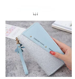 Detail of light blue patchwork wallet with silver sequins and Forever Young logo