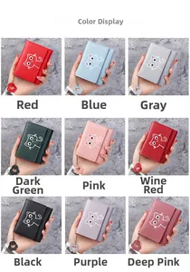 Collection of nine colors of women's short cat wallets with floral zipper pendants