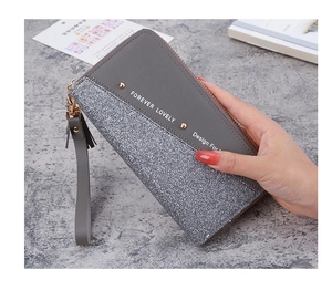 Detail of grey patchwork wallet with silver glitter, tassel, and Forever Lovely text