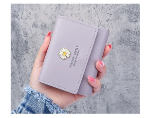 Detail of lilac pebbled leather wallet with daisy hardware and Forever Lovely text