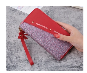 Close-up of red long wallet featuring contrasting glitter sequins and wrist strap