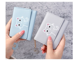Detail of short tri-fold PU leather purses with cartoon cat prints and flower pendants