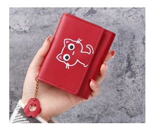 Detailed view of red cat print wallet with matching cat paw pendant charm
