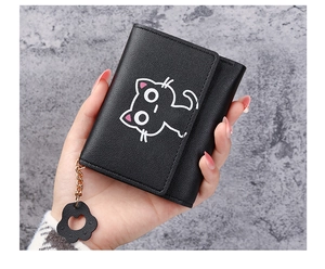 Detail of short leather wallet for women with cartoon cat print and flower pendant