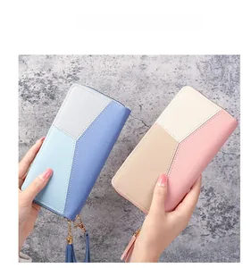 Detail of color-block patchwork women long wallet with tassel zipper and metal hardware