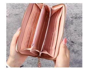 Detailed interior of a pink long zip wallet showing 8 card slots and a coin compartment