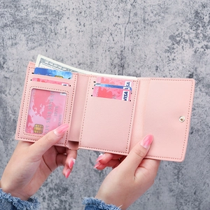 Pink daisy tri-fold wallet for women showing multi-card slots and inner compartments