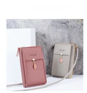 Detail of pink and gray crossbody phone bags with unique leaf-shaped metal zippers