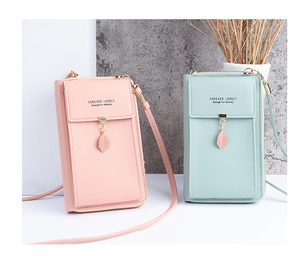Detail of pink and light green PU leather crossbody phone bags with leaf zipper charms
