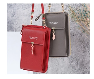 Detail of crossbody phone bags with lychee texture and golden leaf pendant charms