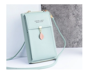 Detail of light green PU leather phone bag with gold metal ring and leaf pendant