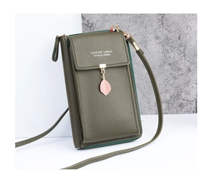 Detail of olive green crossbody phone bag with leaf charm and pebble texture
