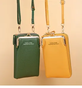 Detail of cross-body phone bags in green and yellow with textured faux leather finish