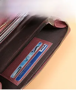 Interior detail of wine red pebbled leather wallet with dual card slots and gold zipper