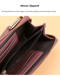 Close-up of magenta leather wallet interior with dual card slots and zippered security pocket