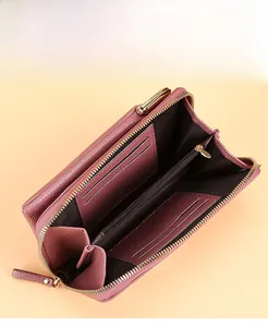 Detail of dusty pink long wallet showing multiple card slots and dual zipper compartments