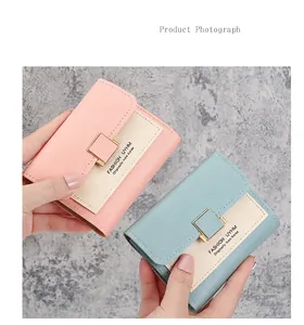 Close-up of contrast color leather wallets with pebble texture and gold buckles