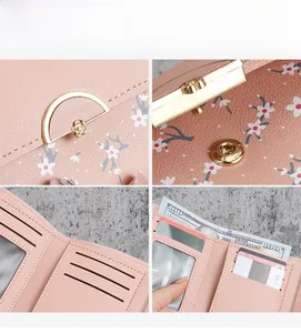 Detailed view of pink cherry blossom leather wallet with floral gold clasp and card slots