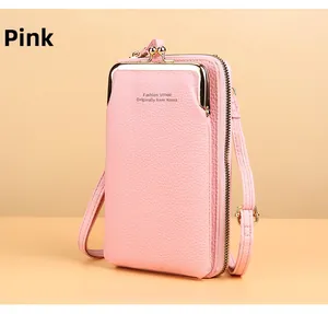 Detailed side view of pink pebbled leather crossbody phone wallet with gold kiss-lock pocket