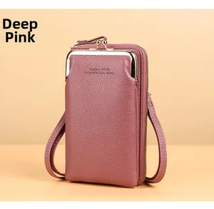 Detail of dark pink litchi grain leather wallet with gold metal clasp and double zippers