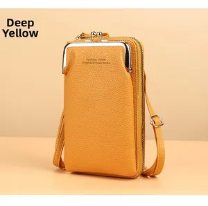 Detail of dark yellow pebbled leather wallet showing metal fastener and zipper texture