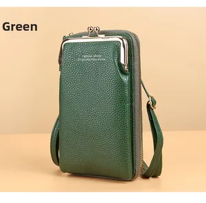 Detail of dark green litchi texture leather wallet with retro metal clasp and zipper