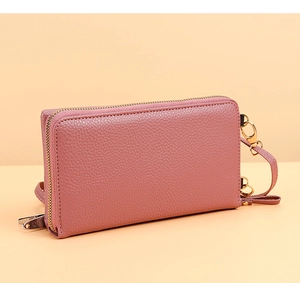 Detailed close-up of dry rose pink lychee leather texture and gold zipper on long wallet