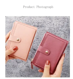 Close-up of pink and burgundy ultra-thin card holders with zipper and leather snap button