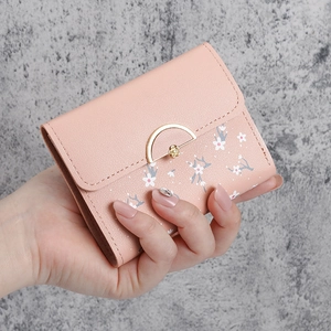 Pink faux leather mini wallet for women featuring a floral pattern and gold metal clasp