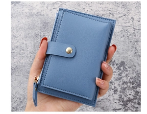 Detail of blue leather slim card holder with zipper and fine lychee grain texture