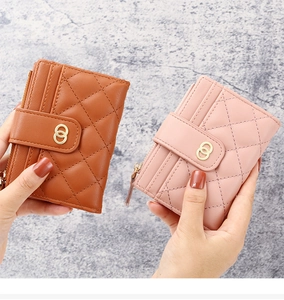 Detail of quilted faux leather wallet with card slots and gold ring buckle